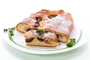 sweet baked homemade plum cake with icing sugar