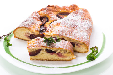 sweet baked homemade plum cake with icing sugar