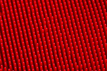 Red silicone massage brash surface texture close up for background