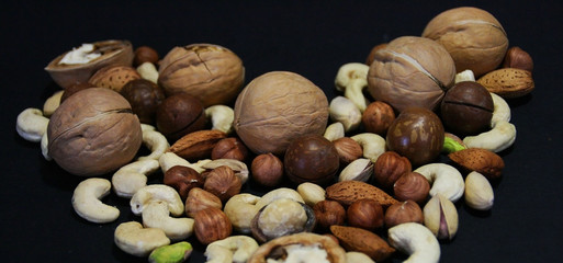 Nuts in bowl on white background, top view with copyspace.  Assorted mixed nuts  isolated on table.