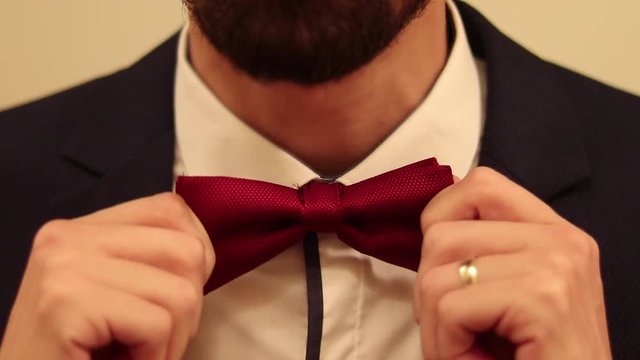 A man tying his bowtie