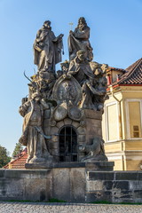 Fototapeta na wymiar Baroque sculpture of John of Matha, Felix of Valois and Saint Ivan on the Charles Bridge, Prague, Czech Republic, sunny day