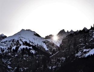sun shines through the martinsloch in winter in elm