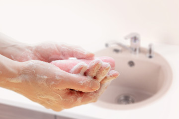 Fototapeta premium Antibacterial soap in the hands. Hand disinfection with soap. Cleanliness and hygiene in everyday life. Hand hygiene