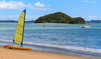A sailing catamaran on the beach at Paihia in the Bay of Islands, New Zealand © Michael