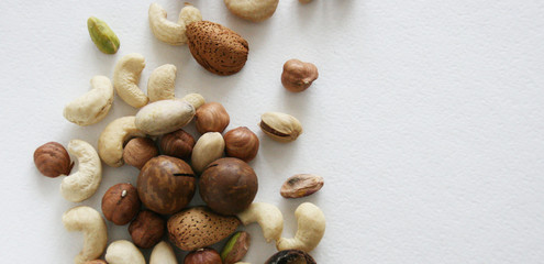 Nuts on black background, top view with copyspace. Assorted mixed nuts   on white table.