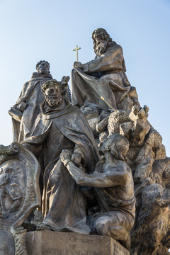 Baroque sculpture of John of Matha, Felix of Valois and Saint Ivan on the Charles Bridge, Prague, Czech Republic, sunny day