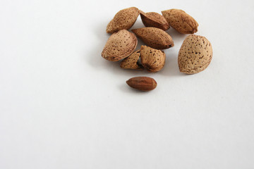 Almond nuts on white background, top view with copyspace.  