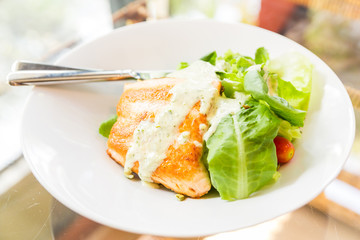 salmon steak in dish on dinner table
