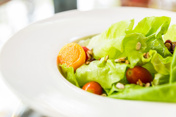 Salad and tomato with cream sauce close up