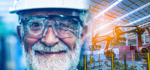 Senior Industry factory Engineer Man monitoring upgrade of robotic in factory by digital hologram...