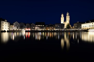 the old town of zurich switzerland on the limmat river at night with the grossmünster