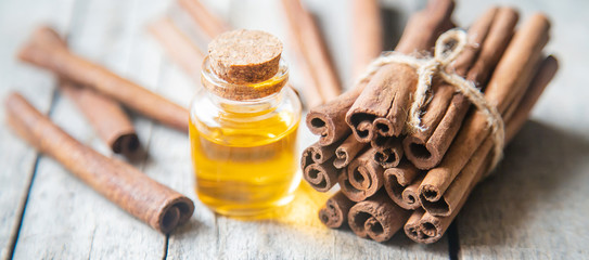 Cinnamon essential oil in a small bottle. Selective focus.