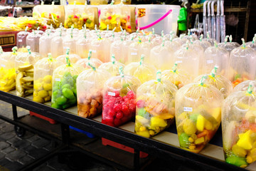 Fruit wrapped in plastic for sale on market, Penang, Malaysia.
