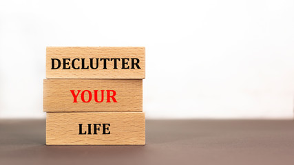 Declutter your life word written on wood block on white background. Time to say text on wooden table for your desing, concept.