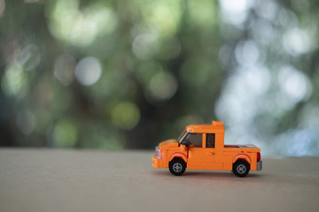 Orange plastic toy car, pickup truck