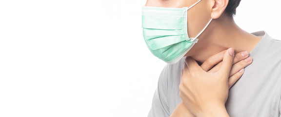 Closeup Young Man in hygienic mask suffering sore throat, 2019-nCoV or coronavirus. Airborne respiratory illness such as pm 2.5 fighting and flu isolated on white background. Banner size.