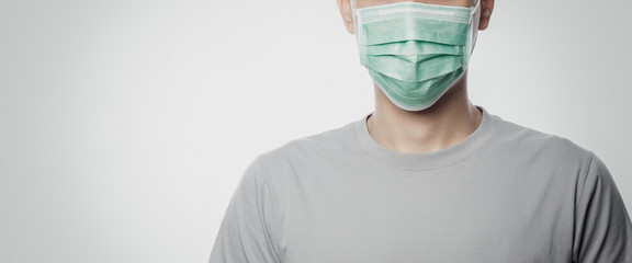 Young Man wearing hygienic mask to prevent infection, 2019-nCoV or coronavirus. Airborne...