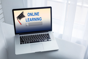Open laptop with screen with text ONLINE LEARNING