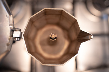 Coffee Moka for Italian espresso. Prepairing breakfast drink. Caffeine aroma. Closeup Traditional empty moka at home, top view