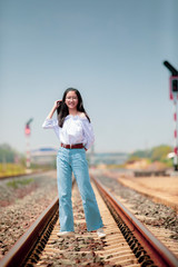 portrait of asian teenager standing on railway track