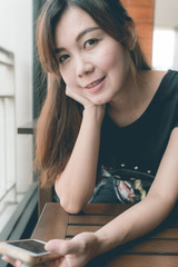 Obraz premium Asian woman portrait in cafe close up