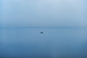 Obraz na płótnie Canvas Boat in Blended Water and Sky