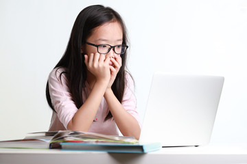 Portrait of frustrated worried young asian girl looks at laptop upset by bad news, negative bullying message, troubled with problem online or email notification.