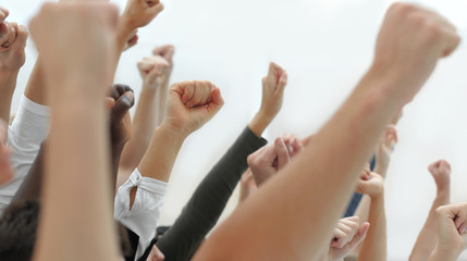 cropped image of a group of young people holding their hands up