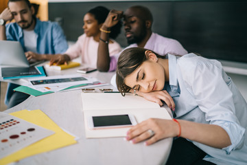 Colleague sleeping at business meeting in office