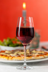 pizza with red wine and a candle