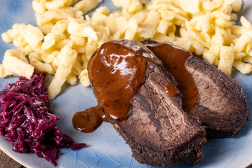 closeup of a german sauerbraten with dumplings