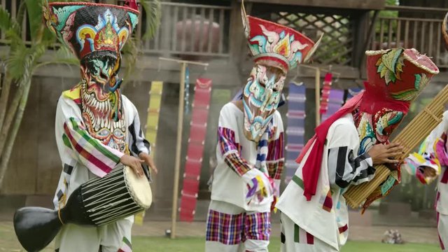 The  people in Thailand on phitakhon ghost festival holiday carnival wearing colorful custume clothes wearing hand paint mask dancing on street with happiness.  