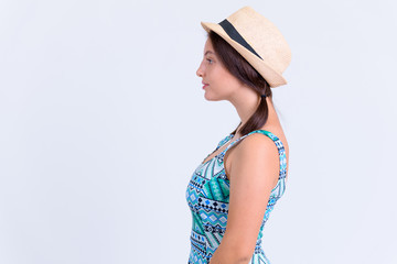 Profile view of young beautiful tourist woman wearing hat