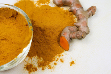 Turmeric powder and fresh turmeric roots isolated on a white background are ingredients in turmeric foods and ingredients in skin care products. Turmeric helps the skin to be strong.