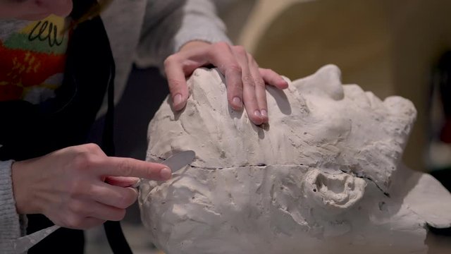 The process of creating sculpture. The sculptor is working. Plaster molding and restoration.