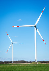 Offshore windmills for renewable energy with blue sky