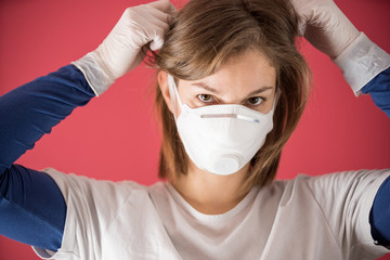nurse surgical gloves puts on molded mask to prevent coronavirus infections and prevent the spread of the world pandemic
