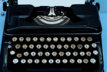 Old vintage typewriter with a blank sheet of paper inserted