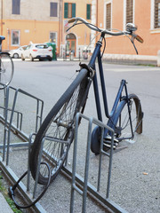 Ferrara, Italy. Downtown, bike rack. Vandalized bicycle.
