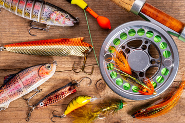 different fishing tackle on wooden background
