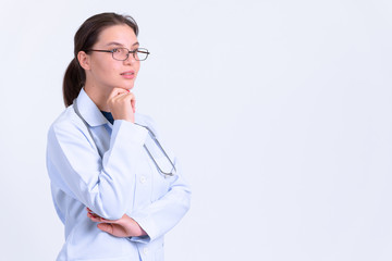 Portrait of young beautiful woman doctor thinking