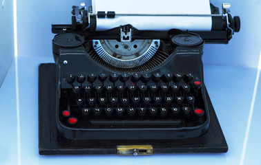 Old vintage typewriter with a blank sheet of paper inserted