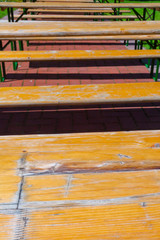 Rows of outdoor wooden benches on a sunny day
