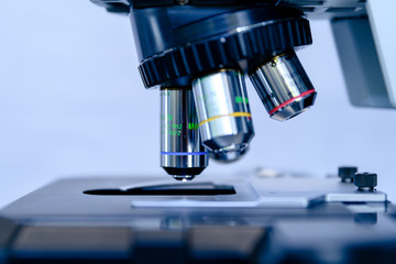 A close up light microscope for pharmaceutical bioscience research. Concept of science, laboratory and study of diseases. Coronavirus (COVID-19) treatment developing.