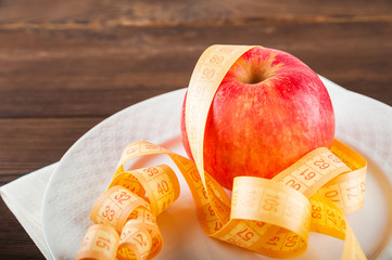 Healthy lifestyle concept. Red apple and centimeter close-up and copy space. Fruit Diet Concept