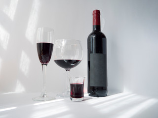 Red wine in a glass on white background