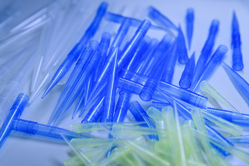 Blue and yellow universal laboratory pipet tips. Laboratory and science material concept.