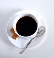 Tea set: mug, saucer and spoon. Coffee in a mug. piece of sugar. On white background.  Ceramics.