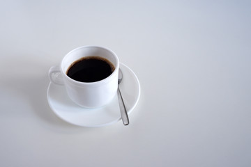Set: mug, teaspoon and saucers. On white background.